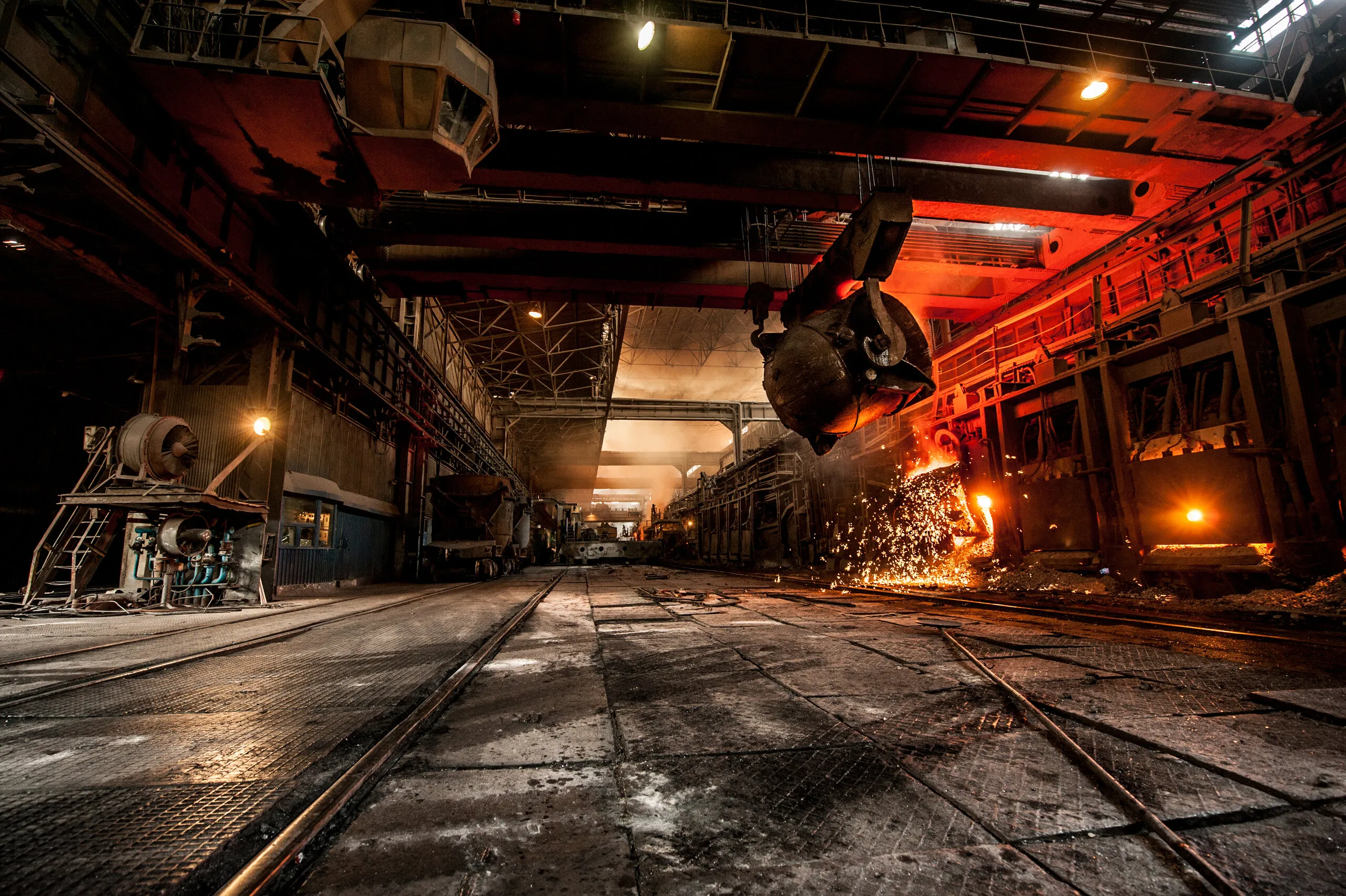 Overhead ladle in a foundry hall, sparks flying