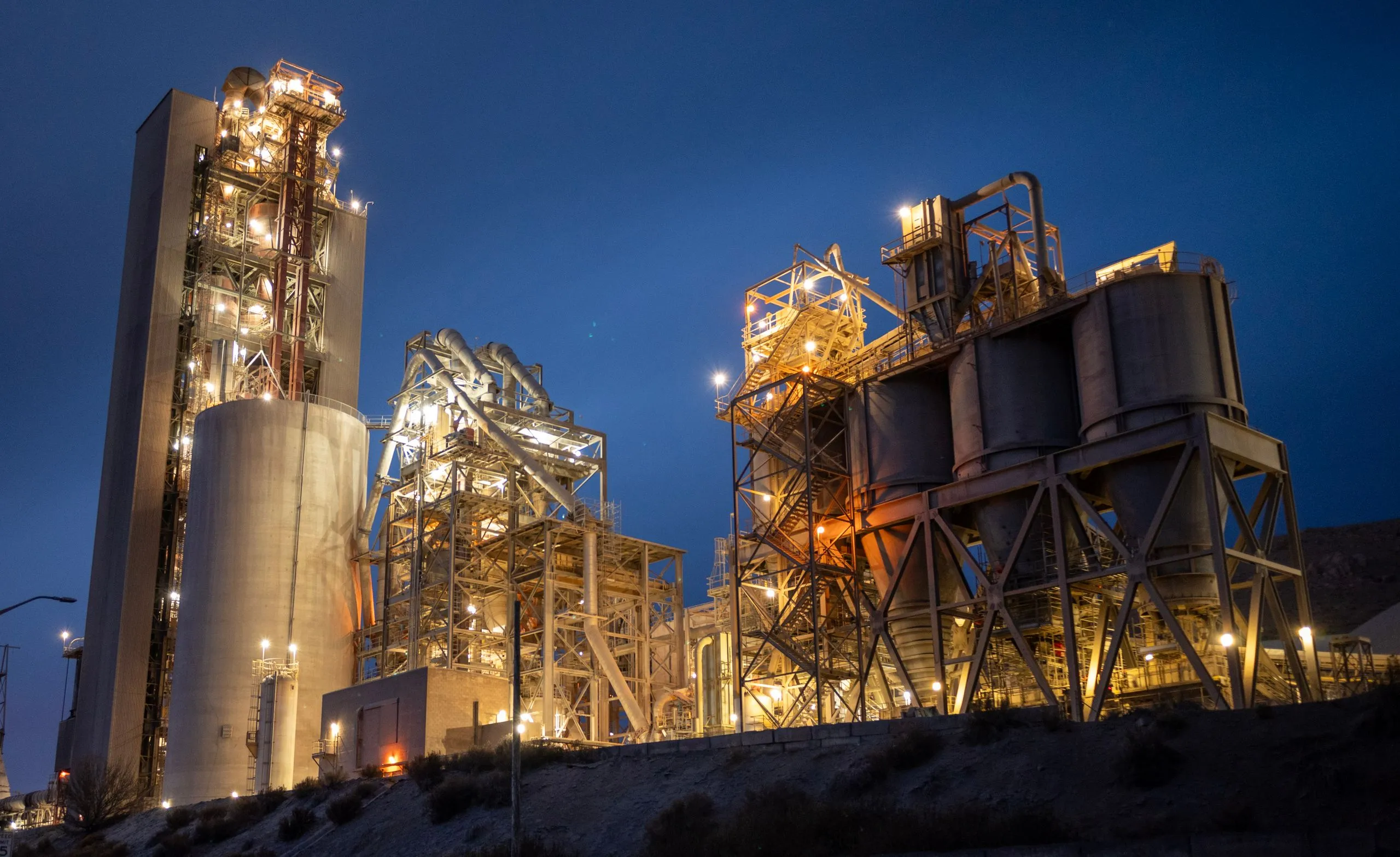 Kiln and preheater towers of a calcining plant lit at night